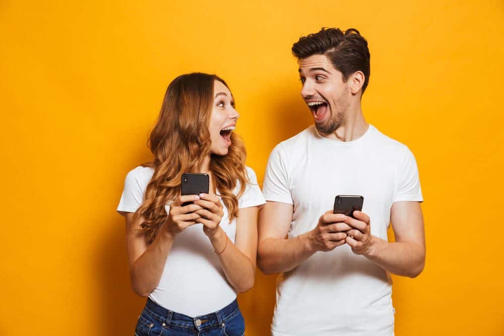 excited people with mobile phones