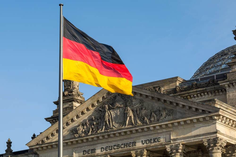 Facade of the German Parliament with the German flag fluttering