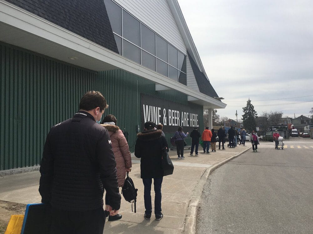 People line up outside Loblaws grocery store during Ontario 3rd wave lockdown in Toronto Canada