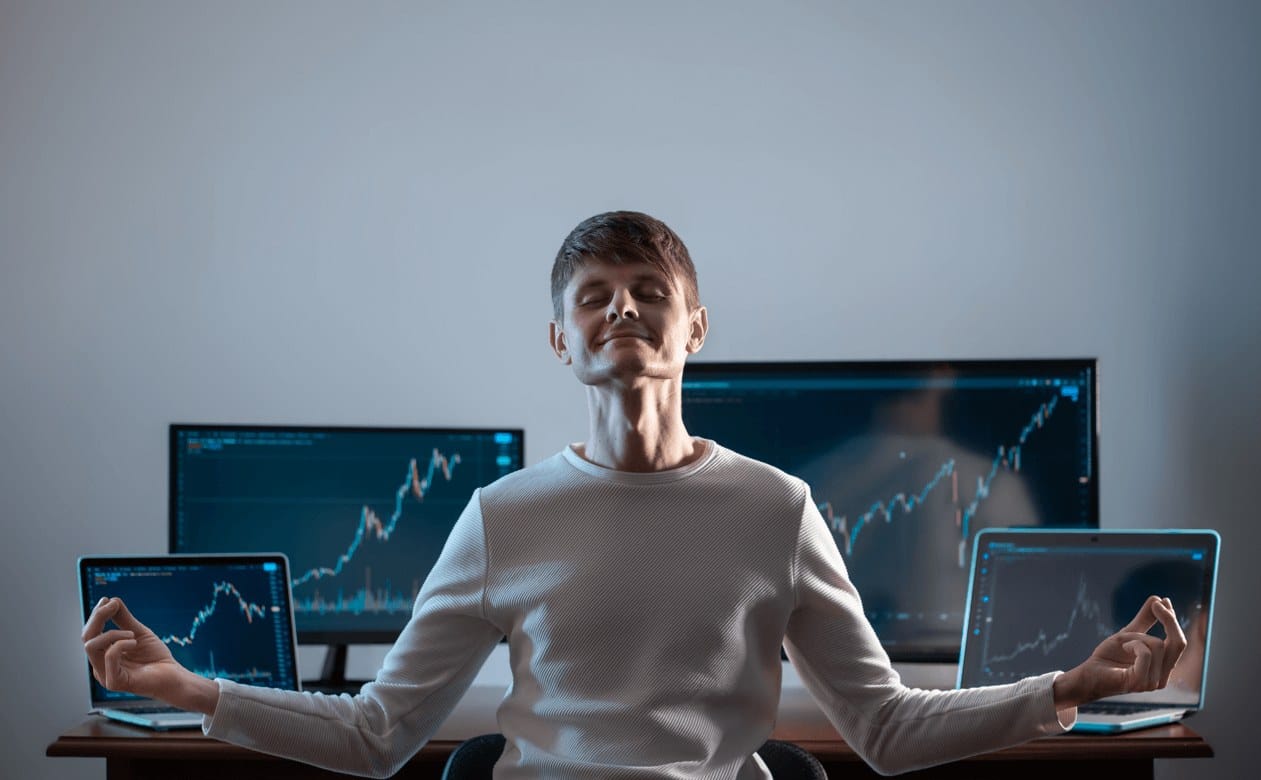 Relaxed successful trader in forex market sitting in front of his monitor charts 1 compressed