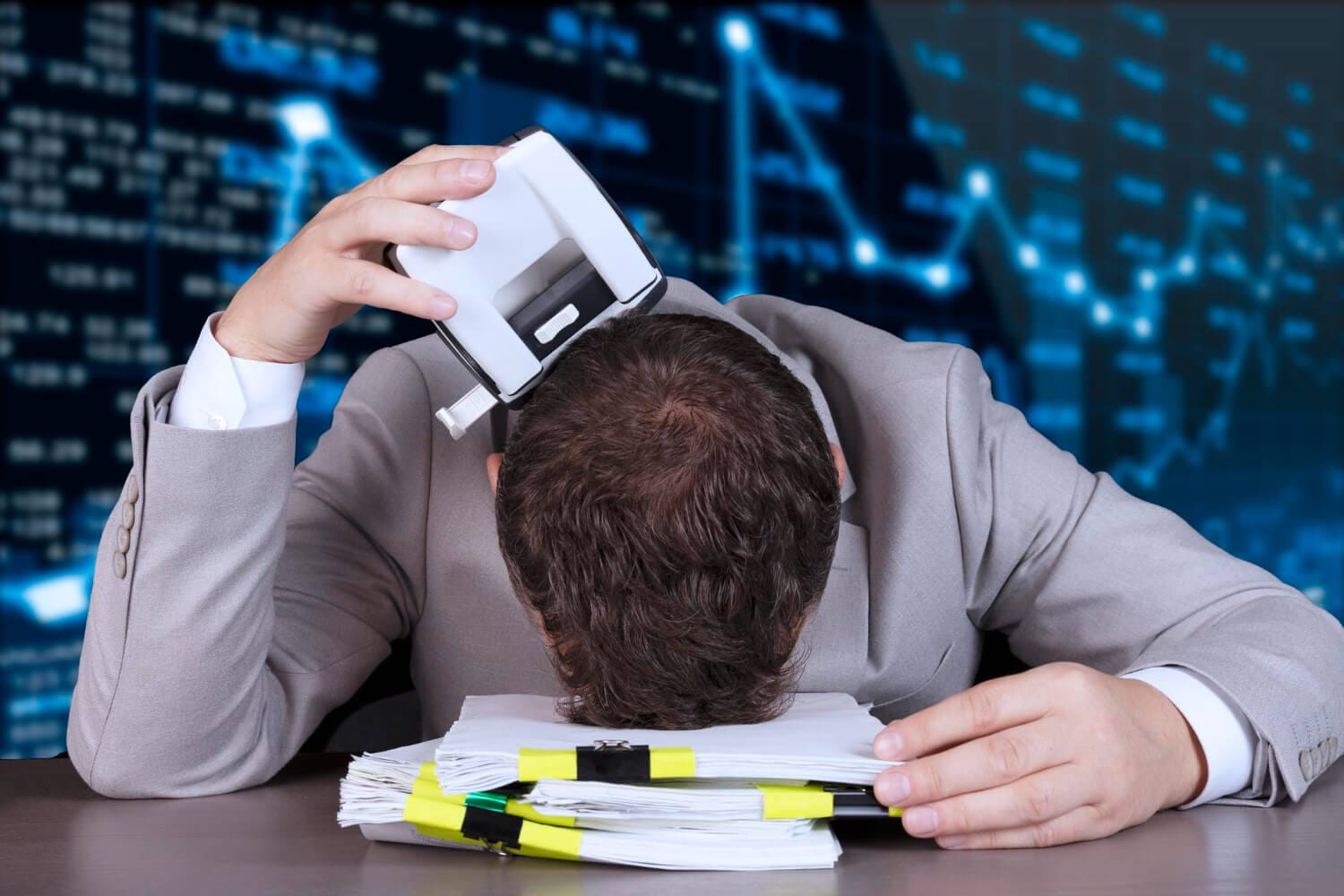 crisis sanctions default businessman lies pile papers holding hole punch against background stock market growth fall graph high quality photo (1)