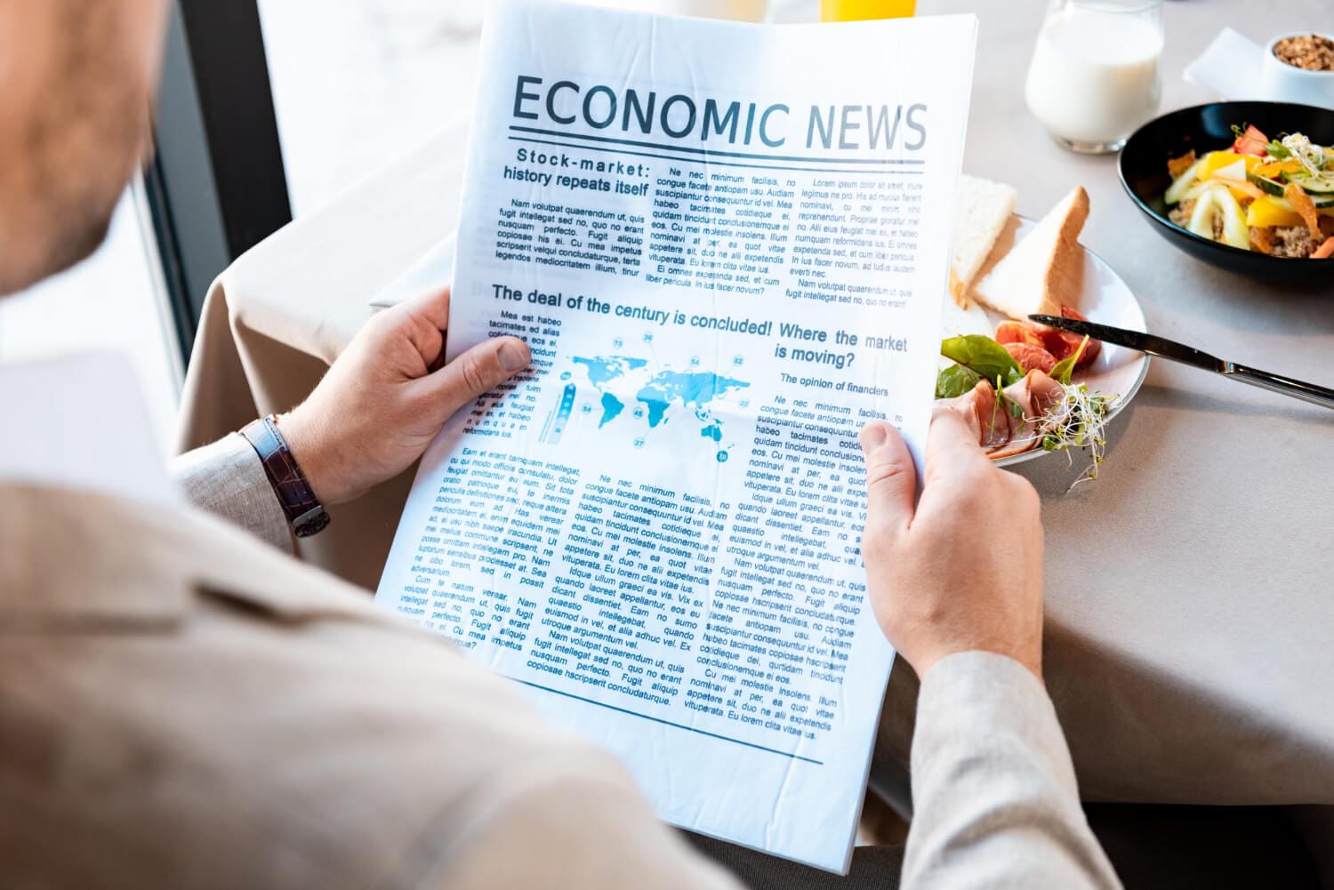 cropped view businessman reading newspaper cafe (1)