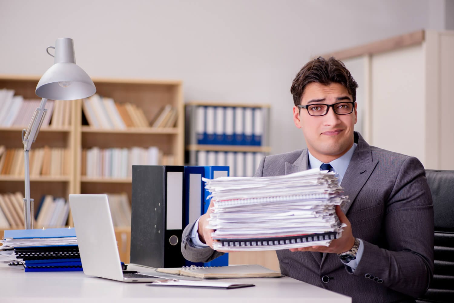 businessman with too much paperwork (1)