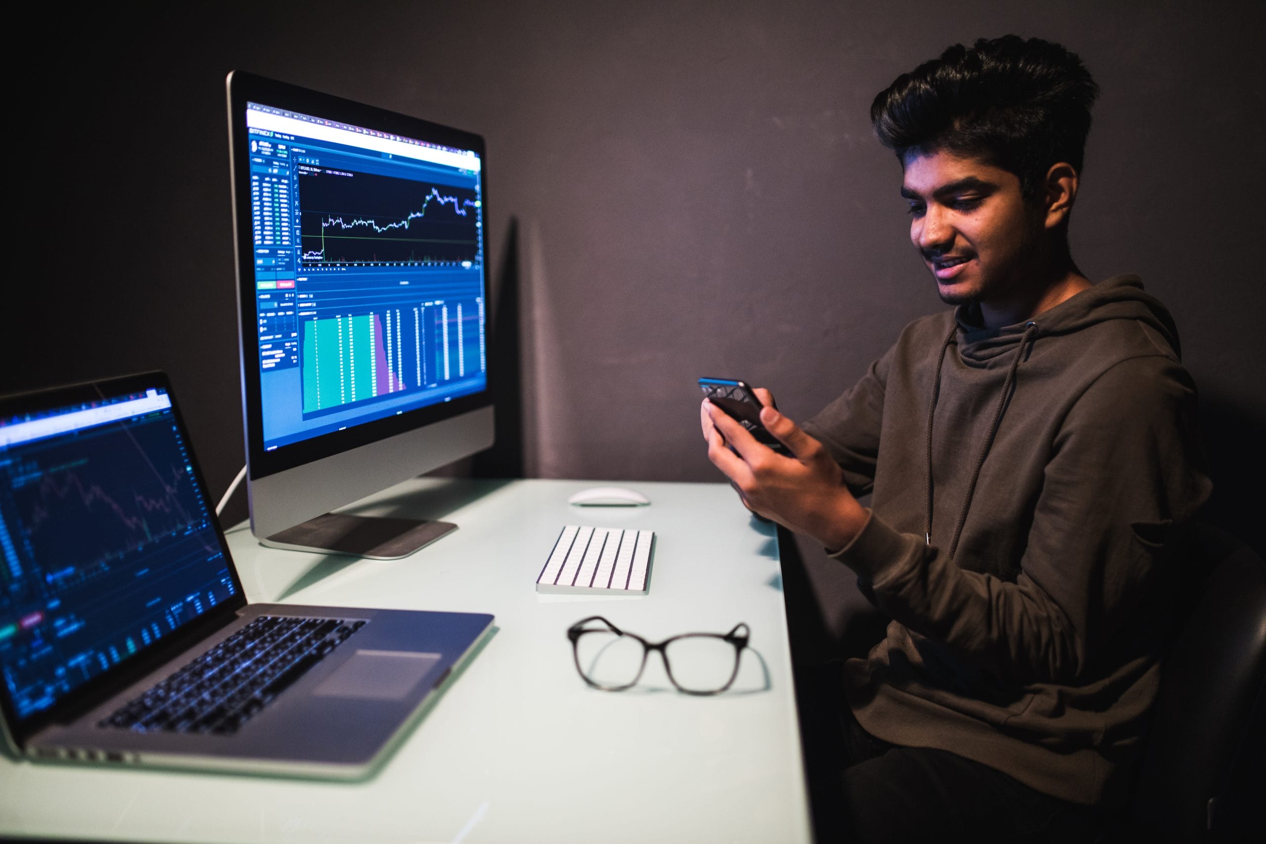 Portrait of successful South Asian employee in formal wear looking at camera during business smartphone conversation, confident corporate boss have cellphone consultancy call during laptop work