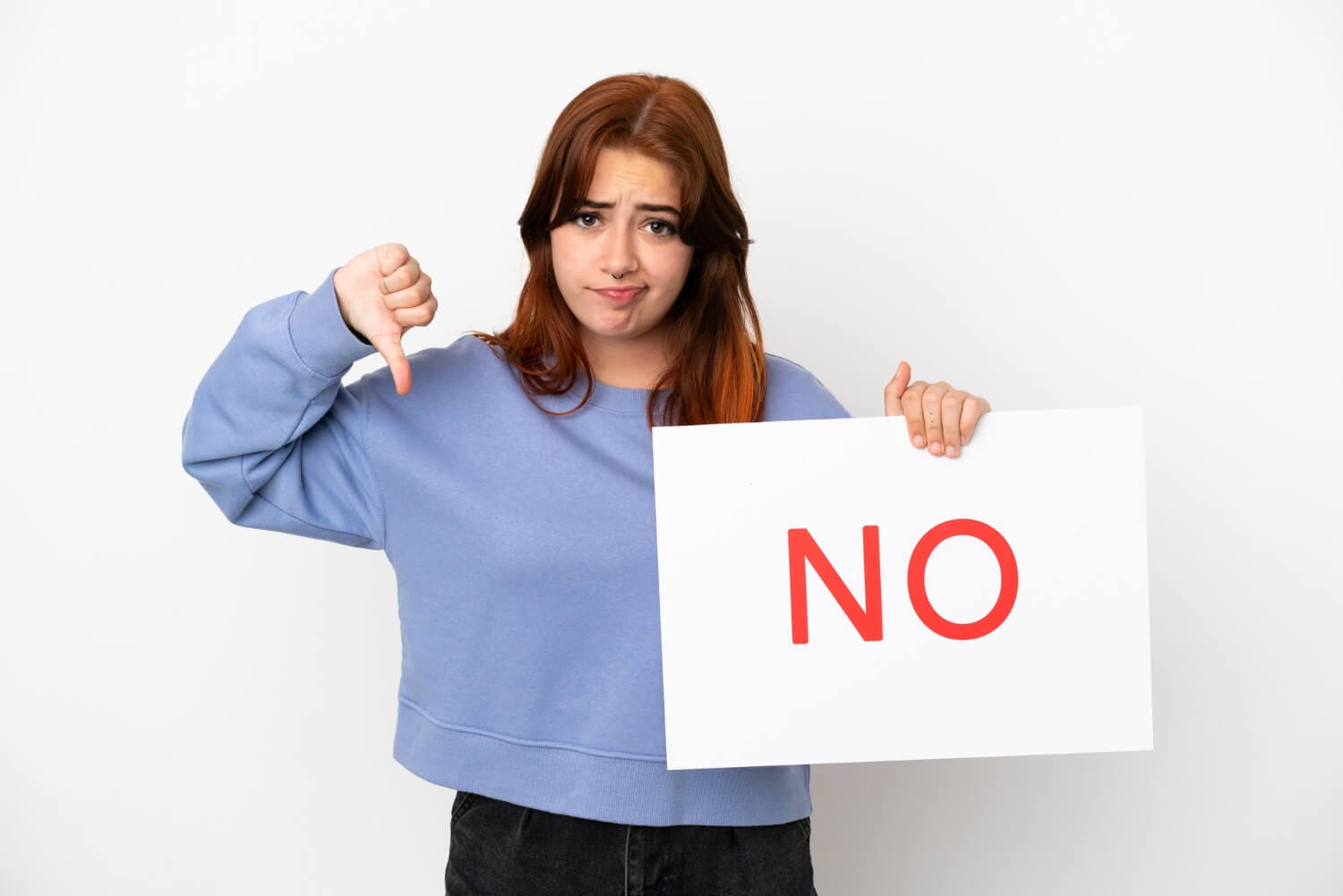 young redhead woman isolated white background holding placard with text no doing bad signal (1)