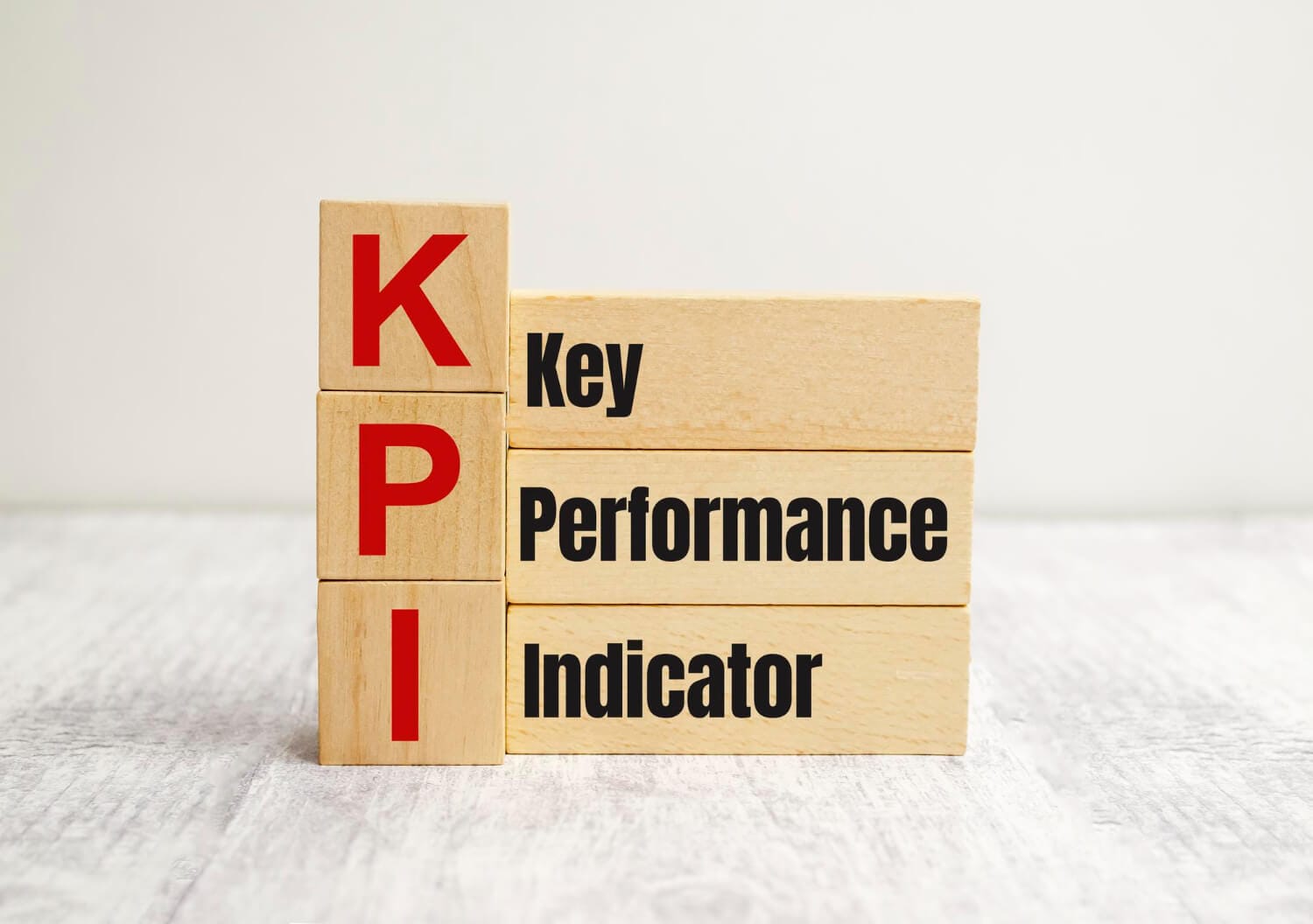 wooden cube block with kpi key performance indicator word table background business concept (1)