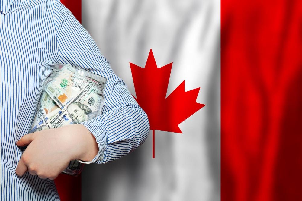 American Dollar banknotes on national Canadian flag